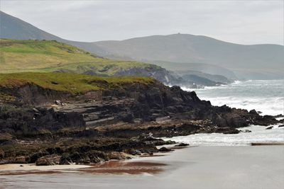 Scenic view of sea and mountains against sky