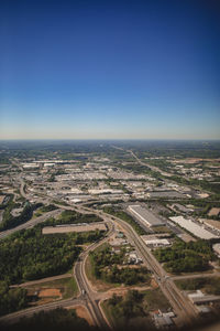 High angle view of city against clear blue sky