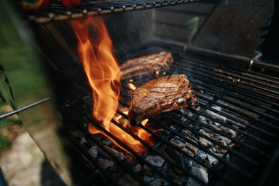 Two iberico steaks on a grill with high flame