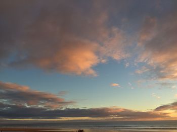 Low angle view of sea against sky during sunset