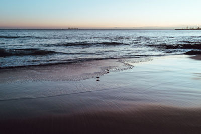 Scenic view of beach against sky during sunset