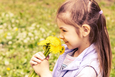 Portrait of young woman holding flower
