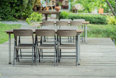 Empty chairs and table in park