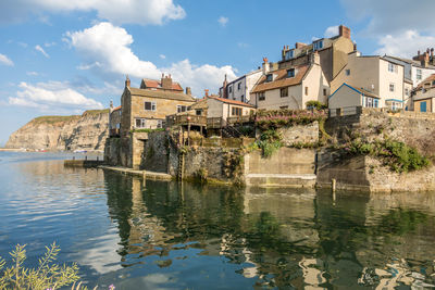 Buildings by old town against sky