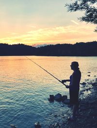 High angle view of woman fishing in lake