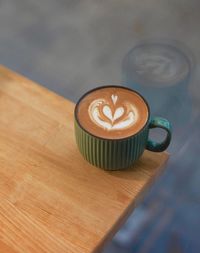 A flat white served in ceramic cup. double shot espresso blend of brazil and sumatra 