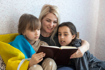 Mother telling story to kids at home