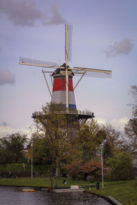 Low angle view of traditional windmill against sky