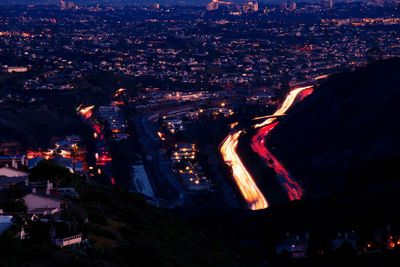 High angle view of illuminated cityscape against sky at night