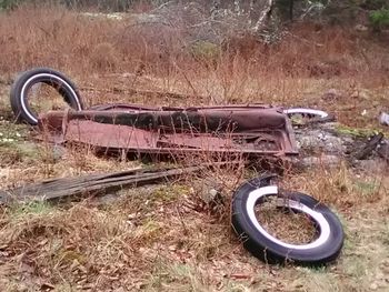 Abandoned vintage car on field