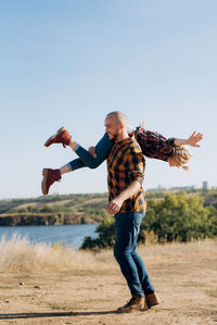 Full length of man standing on field against sky