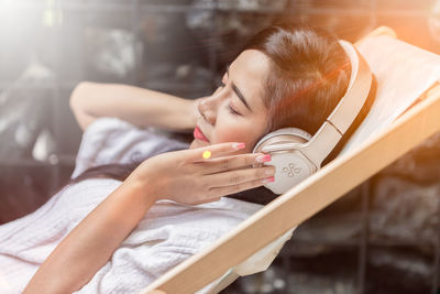 Portrait of woman lying on bed