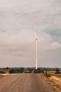 Windmill on field against sky