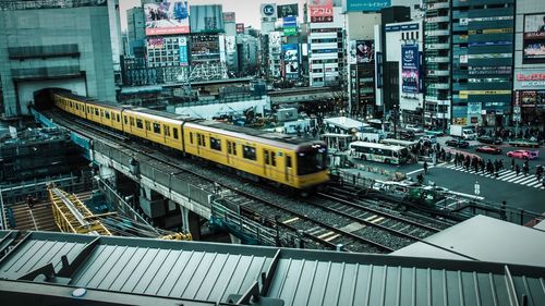 High angle view of train and buildings in city