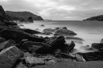 Rocks on shore against sky