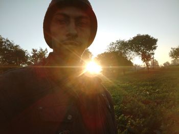 Portrait of man on field against clear sky