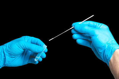 Human hand holding blue background