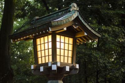 Low angle view of illuminated lanterns hanging by building