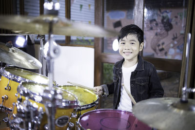 Portrait of boy playing drum