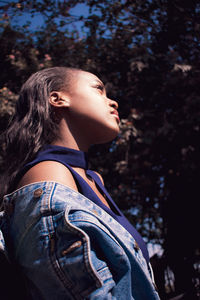Side view of a young woman looking away