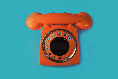 Close-up of telephone booth against blue background