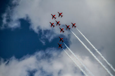 Low angle view of airplane flying against sky