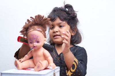 Portrait of cute girl holding stuffed toy