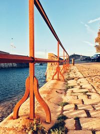 Bridge over river against clear blue sky