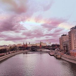 Bridge over river with buildings in background