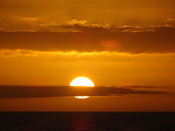 Scenic view of sea against romantic sky at sunset