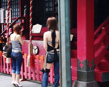 Full length of woman standing by railing