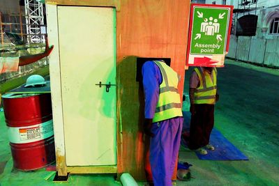 Woman standing by wall