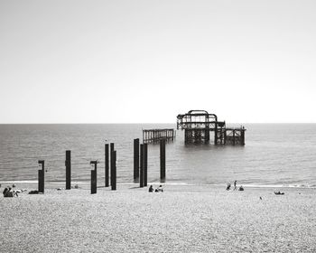 Pier on sea against clear sky