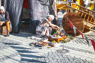 People sitting on footpath