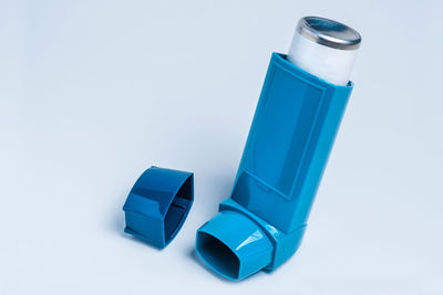 High angle view of blue bottle on white table