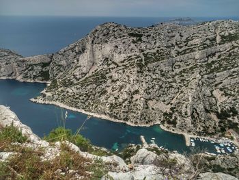 Scenic view of sea and mountains against sky