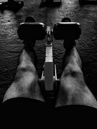 Low section of man holding mobile over water