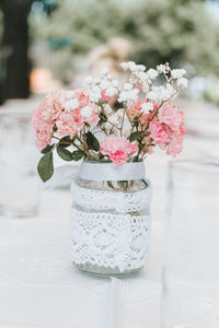 Close-up of pink rose flower vase on table