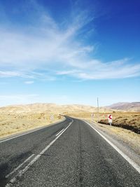 Road passing through landscape against sky