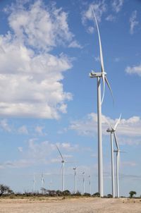 Windmill on field against sky