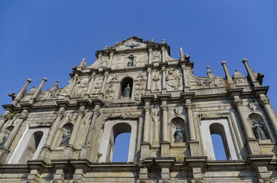 Low angle view of historical building against blue sky