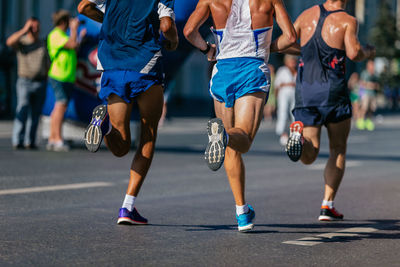 Rear view of people walking on road