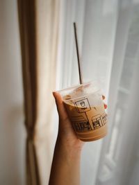 Close-up of hand holding drink