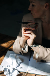 Woman writer, professional content working with papers on table at home.