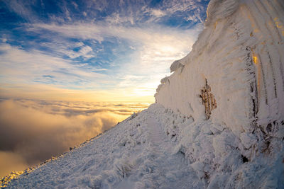 Scenic view of snowcapped mountains against sky during winter