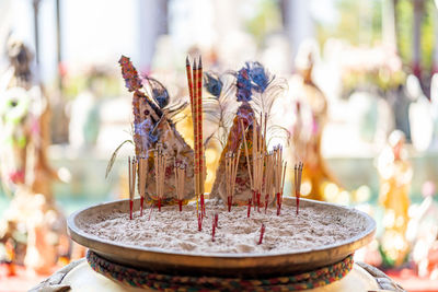 Close-up of cross on table in temple