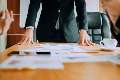 Midsection of man working on table