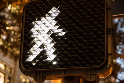 Close-up of a lit pedestrian crossing sign