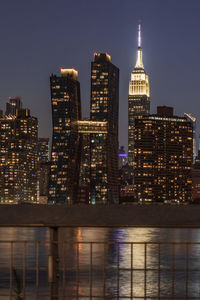 Illuminated buildings against sky at night