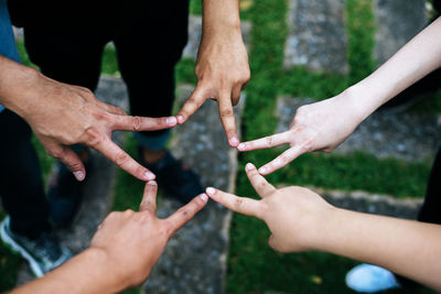 High angle view of people hands against blurred background